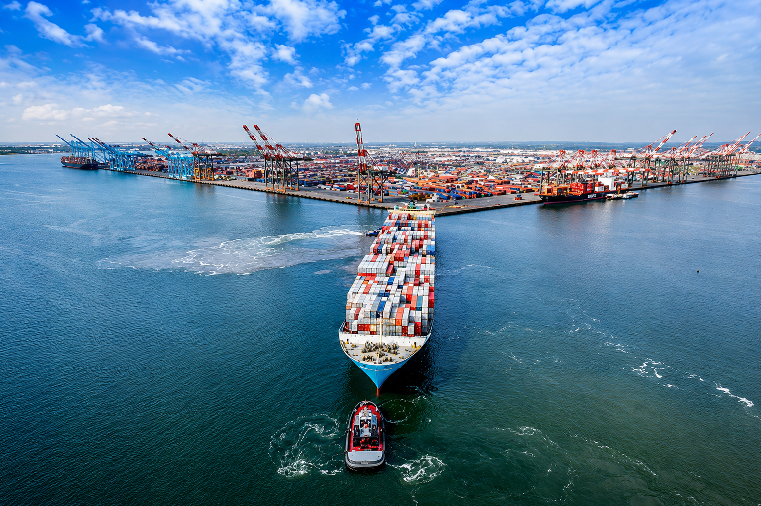 Busy port with container ship and tugboat
